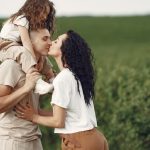 A heartwarming family moment captured in a field, highlighting love and togetherness.